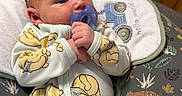 Samuel joined the competition — help win amazing prizes! animal_pattern, baby, baby_sleepwear, bed, blanket, child, clothing, comfort, cushion, cute, indoor, infant, lying_down, newborn, nursery, onesie, pacifier, person, winnie_the_pooh, wooden_wall
