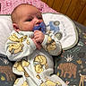 Samuel joined the competition — help win amazing prizes! baby, pacifier, onesie, winnie_the_pooh, cushion, animal_pattern, wooden_wall, bed, blanket, infant, clothing, person, baby_sleepwear, cute, indoor, newborn, comfort, nursery, child, lying_down