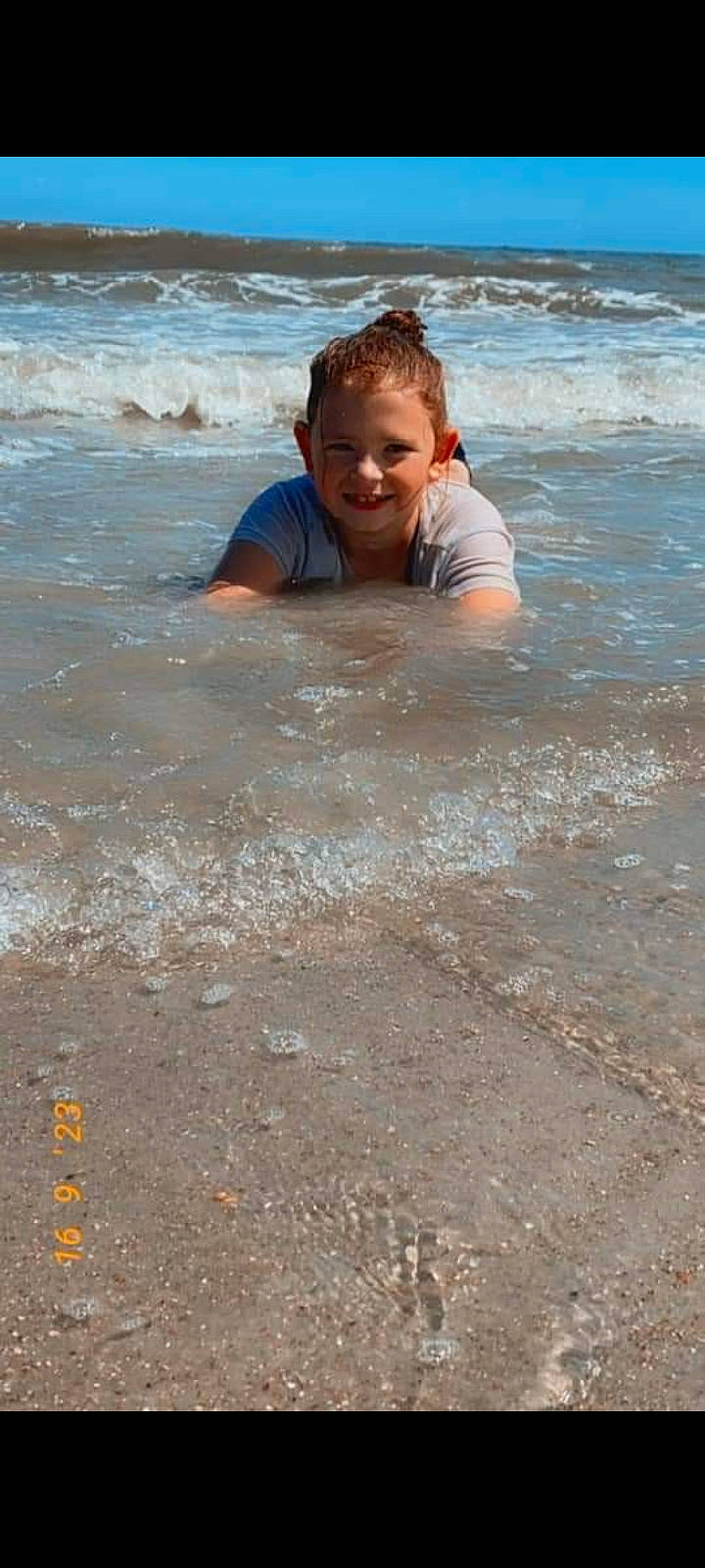 Jacee is registered to the contest to win money with this photo: beach, child, coast, coastal_and_oceanic_landforms, face, fun, happy, joy, leisure, ocean, people_on_beach, person, recreation, sand, shore, smile, soil, toddler, vacation, water