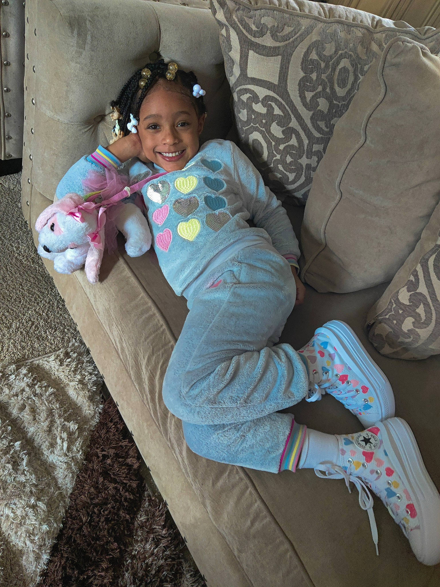 Harlee is registered to the contest to win money with this photo: baby_toddler_clothing, comfort, eye, face, facial_expression, fun, hairstyle, happy, head, human_body, jeans, joy, lap, leg, leisure, person, smile, sneakers, textile, thigh