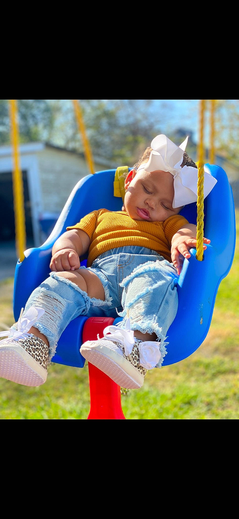 Alonni Kalise joined the competition — help win amazing prizes! baby, child, electric_blue, facial_expression, fun, grass, happy, hat, headwear, human_leg, jeans, lawn, leisure, outdoor_play_equipment, people_in_nature, person, playground, recreation, shoe, sitting