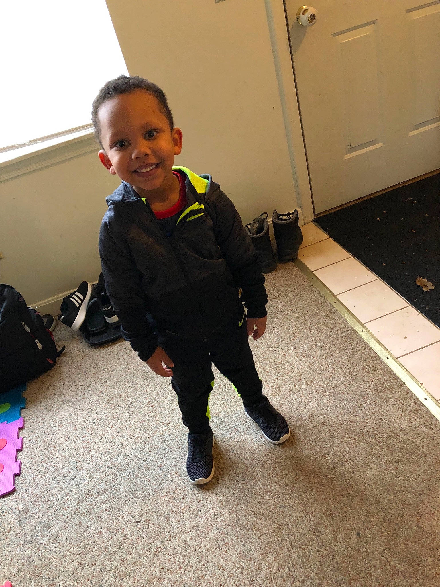 Amadou joined the competition — help win amazing prizes! child, floor, flooring, footwear, fun, joy, outerwear, person, play, shoe, smile, standing, toddler, vacation