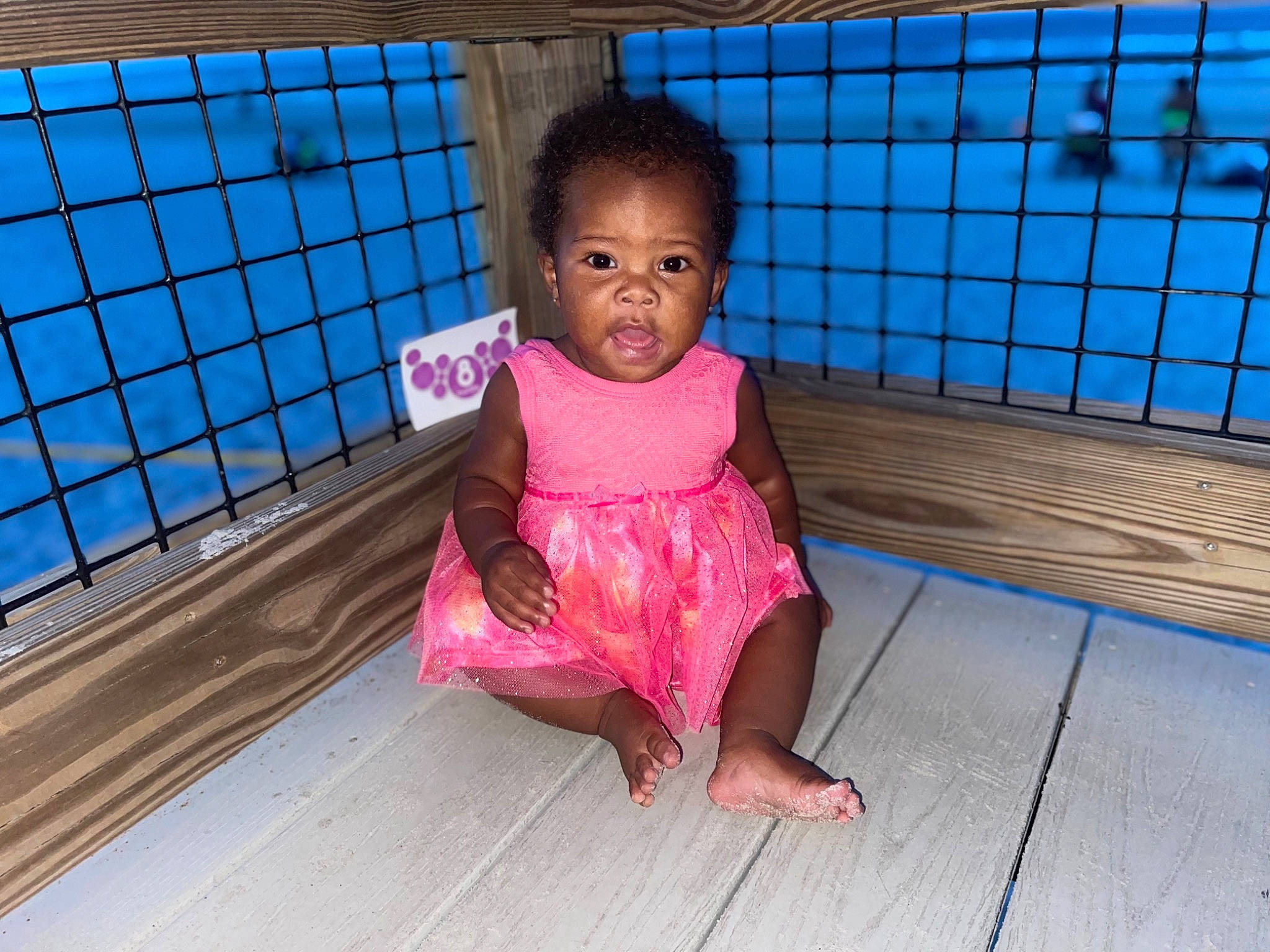 Ariya is registered to the contest to win money with this photo: baby_toddler_clothing, barefoot, child, comfort, crawling, floor, flooring, foot, fun, happy, hardwood, leisure, magenta, mammal, pattern, person, sitting, toddler, vertebrate, water
