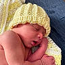 Jamie is registered to the contest to win money with this photo: newborn, baby, sleeping, hat, yellow, knit, blanket, crochet, arm, hand, skin, face, closed_eyes, peaceful, rest, infant, soft, cozy, portrait, indoors