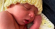 Jamie joined the competition — help win amazing prizes! baby, blanket, child, closeup, cozy, cute, hand, hat, indoors, infant, knitted_hat, newborn, peaceful, portrait, resting, skin, sleeping, soft_texture, warm, yellow