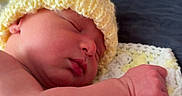 Jamie is registered to the contest to win money with this photo: newborn, baby, sleeping, knitted_hat, yellow_hat, crocheted_blanket, blanket, soft_texture, peaceful, resting, infant, skin, closeup, portrait, indoors, wooden_wall, sleep, cute, toddler, child