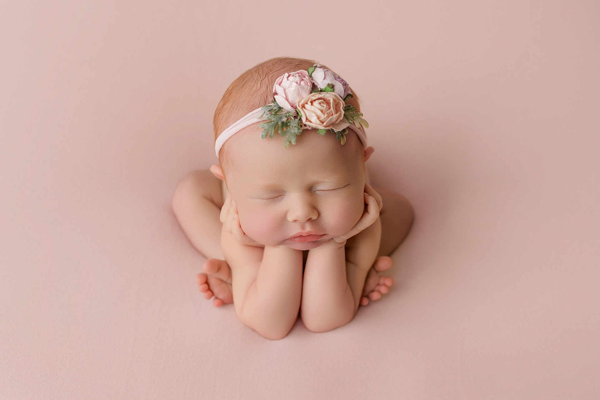Ellie is registered to the contest to win money with this photo: newborn, baby, sleeping, flower_headband, pink_background, peaceful, portrait, infant, cute, hands, legs, skin, head, closed_eyes, soft_light, studio, pose, toddler, child, innocence