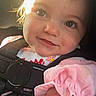 toddler, child, baby, face, smile, car_seat, pink_clothing, sunlight, portrait, young_child, cute, indoors, seatbelt, closeup, happy, person, infant, hair, skin, expression