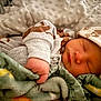 Jackson is registered to the contest to win money with this photo: baby, newborn, sleeping, blanket, hat, clothing, infant, face, hand, soft, cozy, cute, teddy_bear_pattern, bed, warm, closeup, skin, peaceful, child, portrait