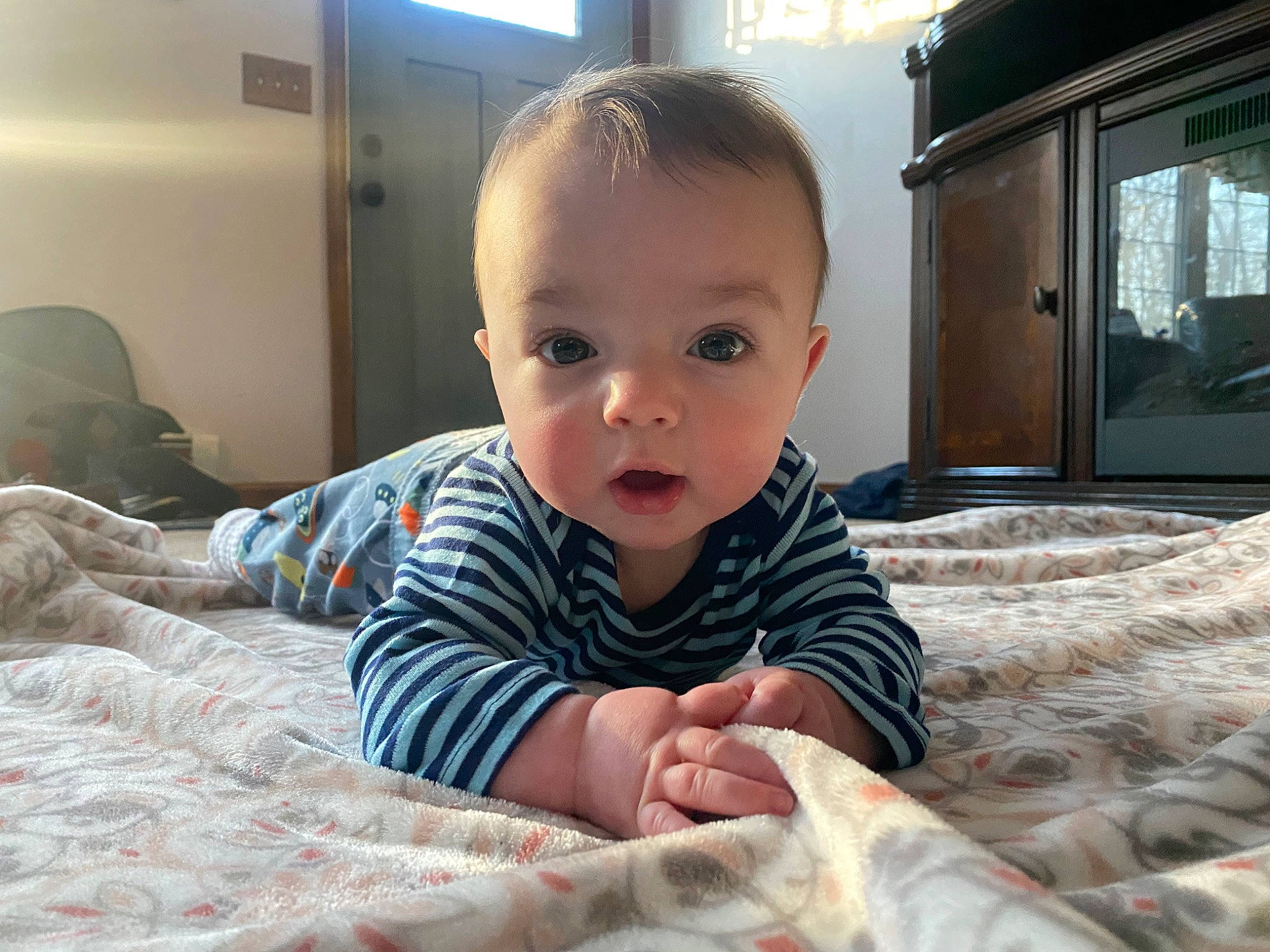 Riley joined the competition — help win amazing prizes! baby, baby_toddler_clothing, bed, bedding, cheek, child, comfort, crawling, flooring, fun, happy, linens, person, room, sitting, skin, smile, toddler, tummy_time, vacation