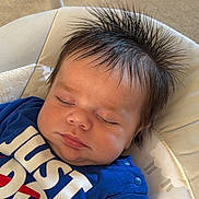 Oakley is registered to the contest to win money with this photo: baby, sleeping, blue_clothing, hair, spiked_hair, face, child, infant, cushion, seat, pattern, sheep_pattern, soft_fabric, closeup, indoors, peaceful, resting, cute, adorable, portrait