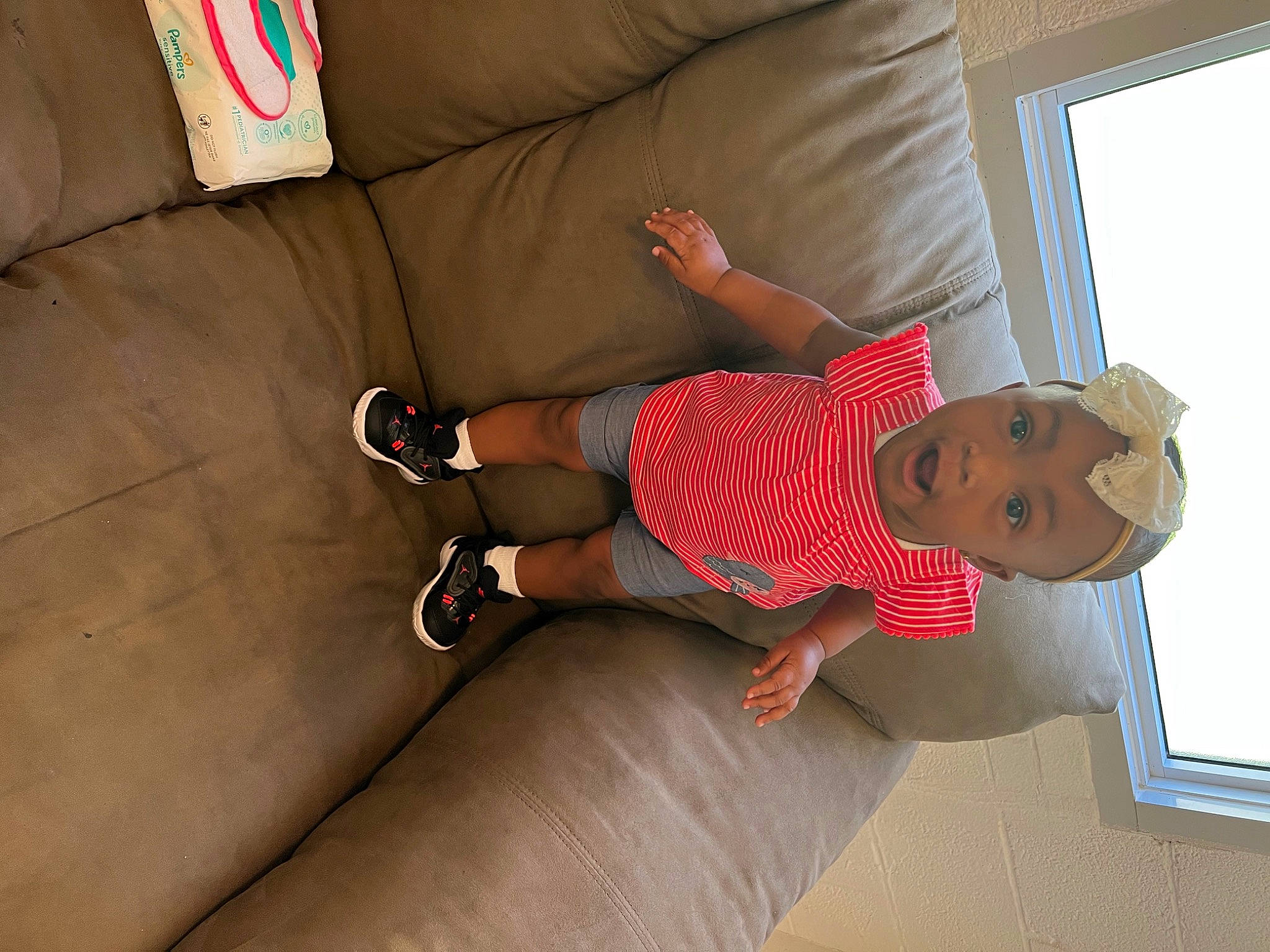 Adilynn joined the competition — help win amazing prizes! baby, baby_toddler_clothing, child, comfort, elbow, finger, floor, flooring, foot, hardwood, hat, human_leg, knee, leg, person, room, sock, surprise, thigh, toddler