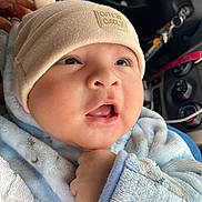 Ezequiel joined the competition — help win amazing prizes! baby, infant, cute, hat, clothing, blue, beige, face, eyes, mouth, hand, car_interior, keys, cozy, warm, soft, portrait, closeup, child, cuddly