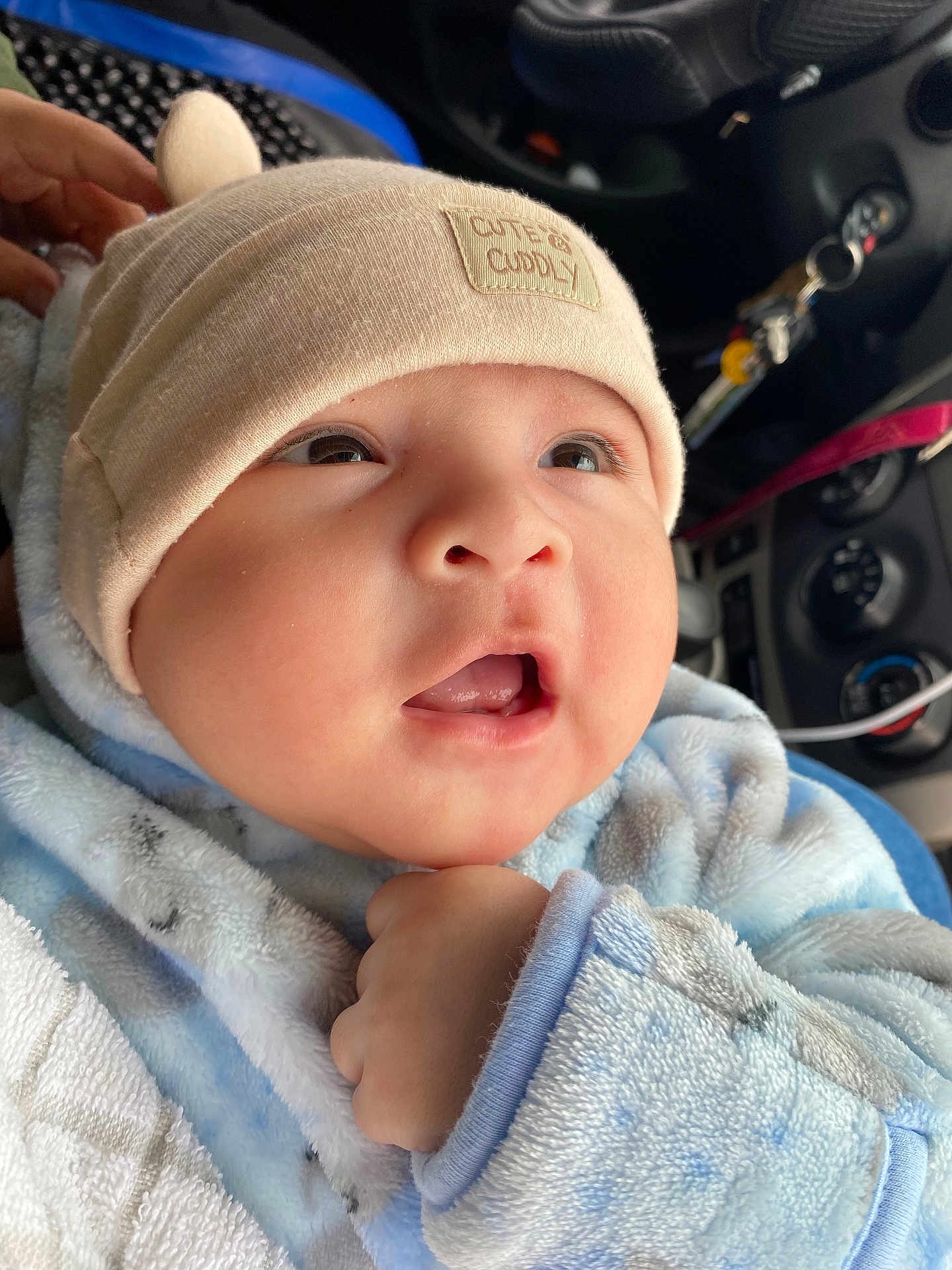 Ezequiel joined the competition — help win amazing prizes! baby, infant, cute, hat, clothing, blue, beige, face, eyes, mouth, hand, car_interior, keys, cozy, warm, soft, portrait, closeup, child, cuddly