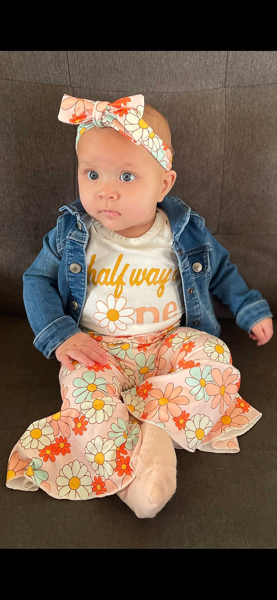 Zayla joined the competition — help win amazing prizes! baby, baby_toddler_clothing, beanie, cap, cheek, child, collar, costume_hat, eye, face, happy, head, headwear, outerwear, pattern, peach, person, sitting, skin, sleeve