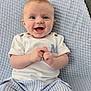baby, child, smiling, happy, face, clothing, blue_blanket, striped_pants, white_shirt, sitting, hands, cute, infant, portrait, indoor, soft_texture, light_blue, button_detail, young, person