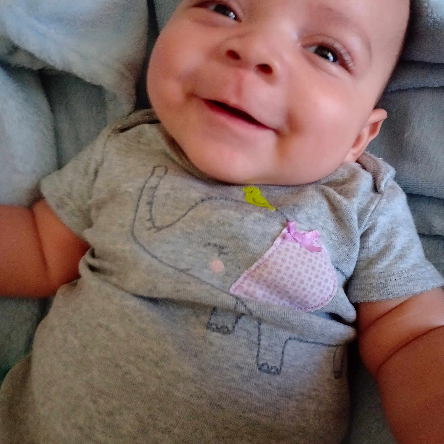 Milo joined the competition — help win amazing prizes! baby, blanket, clothing, couch, cushion, face, furniture, happy, head, homedecor, laughing, linen, newborn, pants, person, photography, portrait, shirt, smile, t_shirt