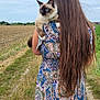 person, cat, long_hair, blue_eyes, patterned_dress, field, grass, path, outdoor, cloudy_sky, nature, animal, pet, holding, back_view, fur, ears, rural, summer, scenic