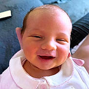 Halo joined the competition — help win amazing prizes! baby, smiling, infant, face, pink_clothing, cute, portrait, person, newborn, happy, closeup, soft_lighting, indoors, couch, button, bunny, collar, skin, head, expression