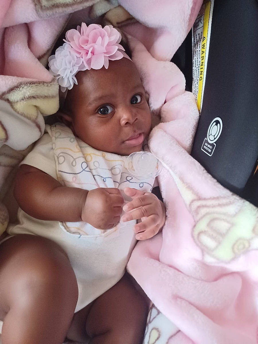 Aila joined the competition — help win amazing prizes! baby_toddler_clothing, comfort, dress, eye, eyelash, finger, gesture, hand, happy, head, headwear, leg, muscle, nail, person, petal, pink, skin, textile, thigh