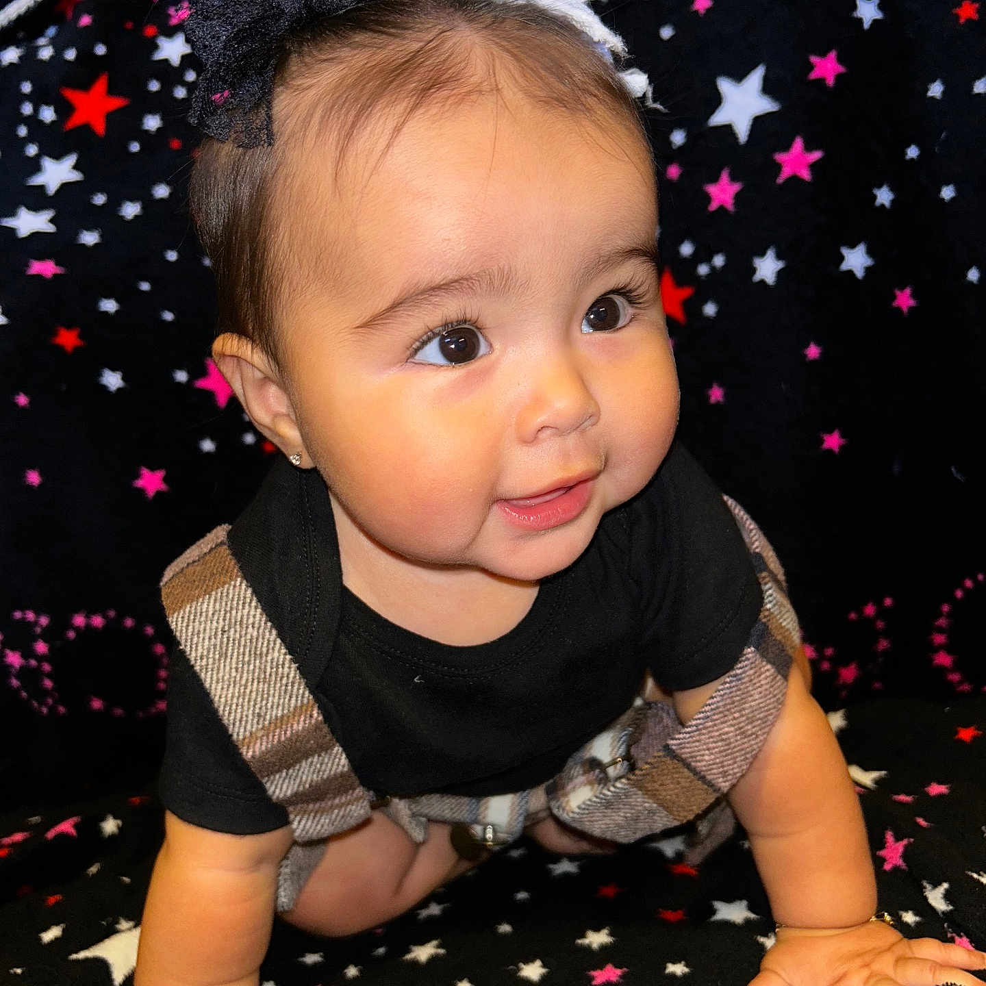 Valenciannah joined the competition — help win amazing prizes! baby, black_shirt, blanket, bows, cheeks, child, clothing, crawling, cute, eyes, face, hands, happy, indoors, infant, person, plaid_overalls, portrait, smiling, star_pattern
