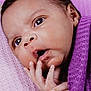 baby, child, close_up, curious, cute, expression, eyes, face, hand, indoors, infant, lying_down, newborn, peaceful, portrait, purple_blanket, skin, small_fingers, soft_texture, wrapped