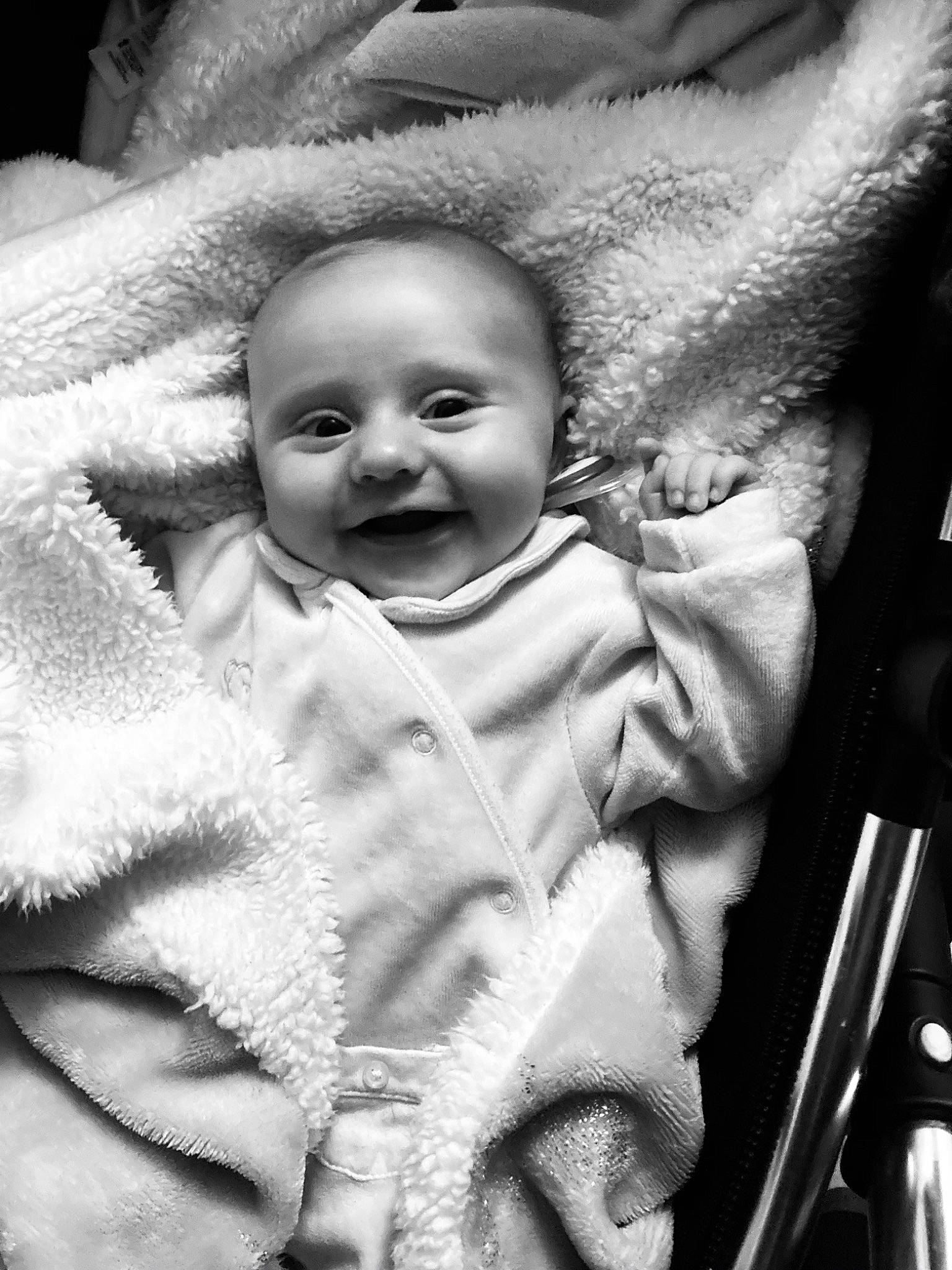 Mabel is registered to the contest to win money with this photo: baby, baby_products, black_and_white, cheek, child, eye, face, facial_expression, head, joy, laugh, monochrome, monochrome_photography, people, person, photography, product, skin, smile, style
