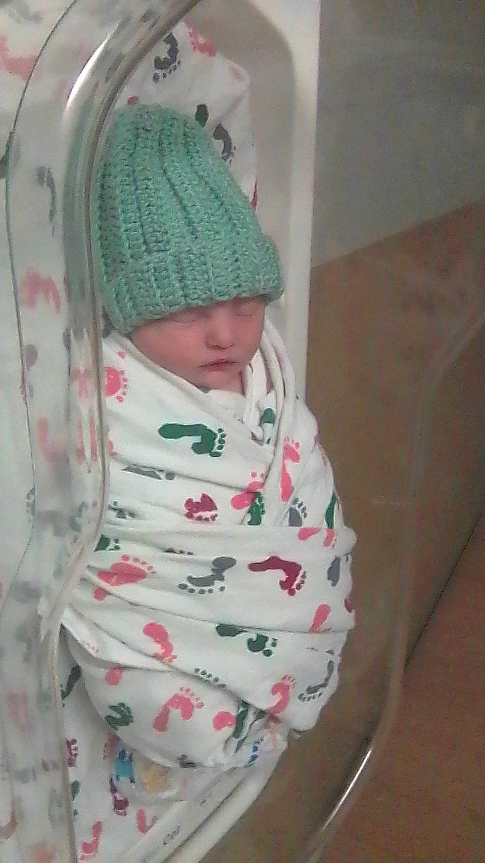 Noah is registered to the contest to win money with this photo: baby, baby_products, baby_safety, baby_sleeping, baby_toddler_clothing, beanie, cap, child, comfort, headwear, knit_cap, linens, magenta, outerwear, pattern, person, room, service, sleeve, textile