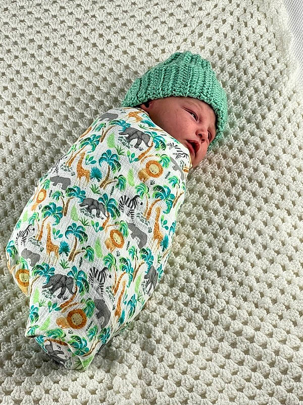 Noah is registered to the contest to win money with this photo: baby, baby_products, baby_sleeping, baby_toddler_clothing, beanie, cap, child, comfort, headwear, knit_cap, linens, pattern, person, sleep, sleeve, toddler, wool