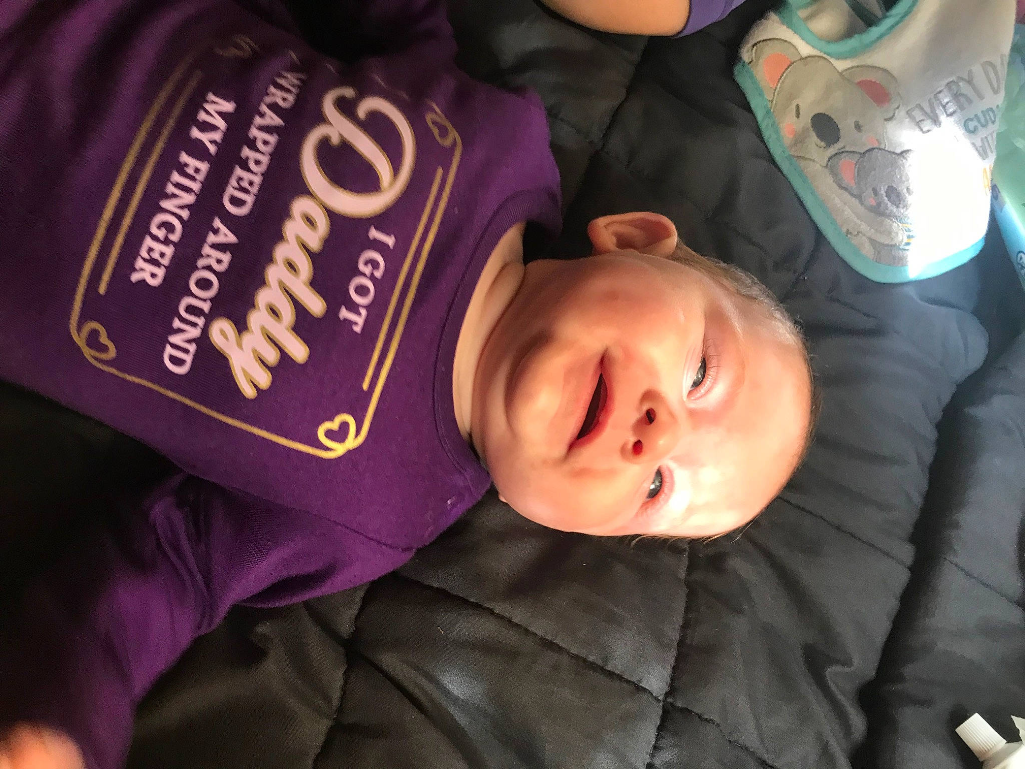 Alaska is registered to the contest to win money with this photo: cheek, chin, comfort, cool, eye, eyebrow, face, facial_expression, forehead, happy, head, mouth, organ, person, product, purple, skin, sleeve, smile, toddler