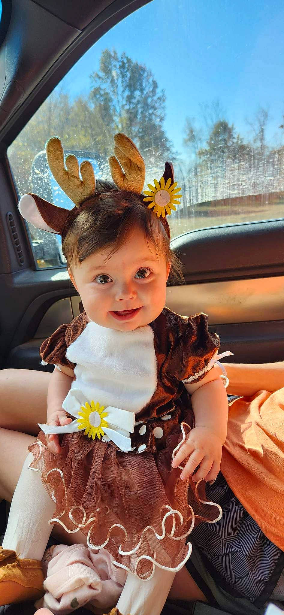 Paisley is registered to the contest to win money with this photo: beauty, blond, bridal_clothing, car, dress, event, facial_expression, formal_wear, fun, gesture, hairstyle, happy, headpiece, person, petal, snapshot, textile, toddler, tree, vehicle_door