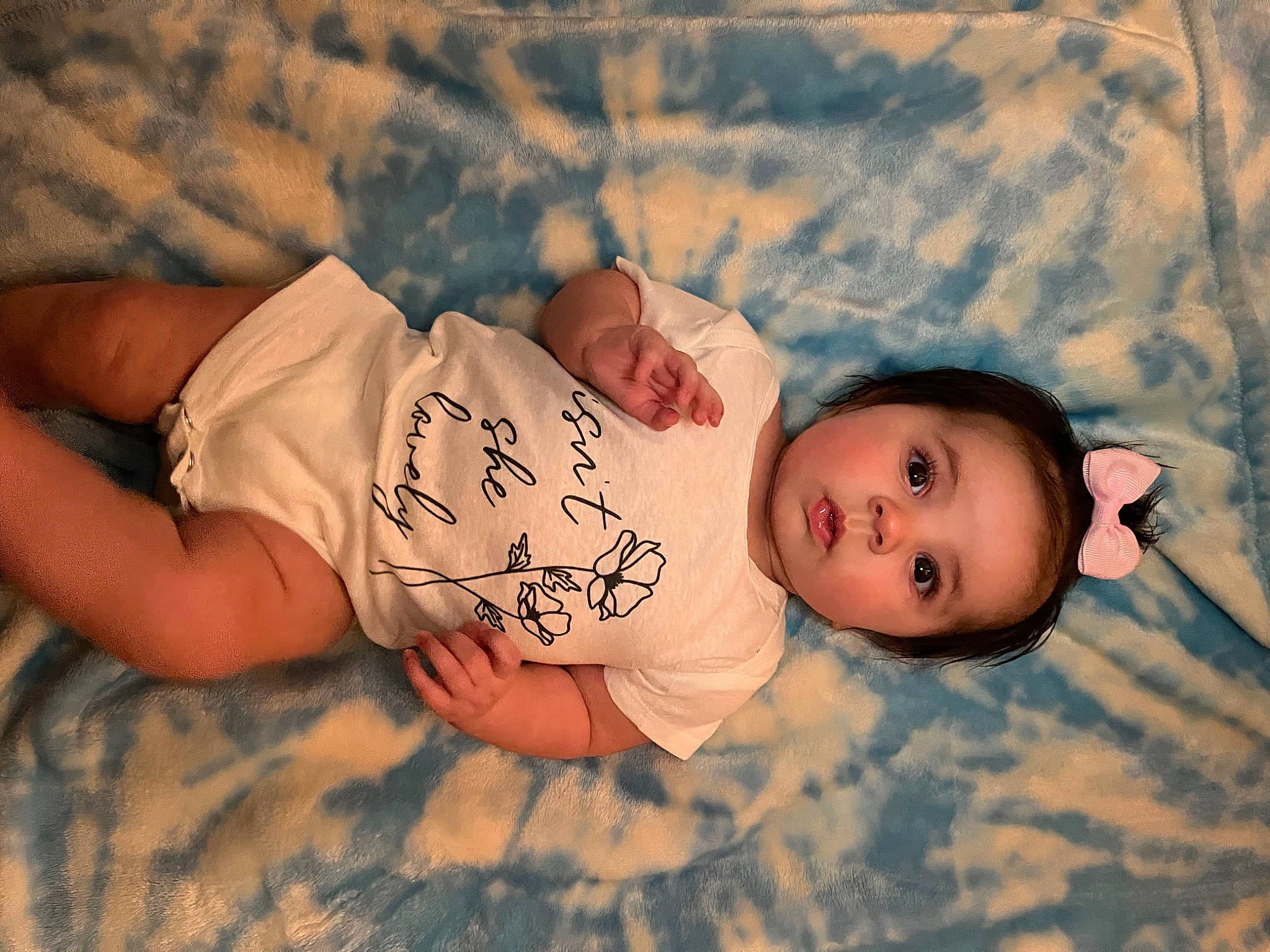 Serena is registered to the contest to win money with this photo: baby, baby_toddler_clothing, cheek, child, chin, comfort, eye, face, fun, grass, happy, head, human_body, mouth, nose, pattern, person, sitting, skin, toddler