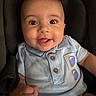 Bryan is registered to the contest to win money with this photo: baby, blue_shirt, car_seat, child, closeup, clothing, cute, expression, face, happy, harness, indoors, infant, person, portrait, seat, sitting, smiling, tongue_out, young