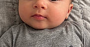 Bryan joined the competition — help win amazing prizes! baby, infant, face, eyes, hands, clothing, shirt, text, blanket, quilt, lying_down, cute, child, skin, portrait, expression, indoors, person, young, toddler
