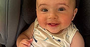 Bryan is registered to the contest to win money with this photo: baby, car_seat, child, clothing, comfort, cute, eyes, fabric, face, fingers, hand, happy, indoor, infant, mouth, person, ring, seat, skin, smiling
