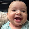 baby, smiling, infant, face, close_up, child, car_interior, knitted_blanket, happy, person, cute, young_child, apparel, seat, portrait, skin, head, mouth_open, eyes, human