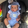 Bryan joined the competition — help win amazing prizes! baby, infant, car_seat, hat, overalls, teddy_bear, white_socks, fan, child, cute, comfort, seat, clothing, sun_hat, indoor, portrait, person, baby_toys, relaxing, warm_light