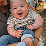Elïo a rejoint le concours — aidez-le/la à gagner de superbes lots ! baby, smiling, happy, child, person, adult, holding, outdoor, daylight, casual_clothing, jeans, sock, striped_shirt, face, portrait, cute, family, love, parent, event