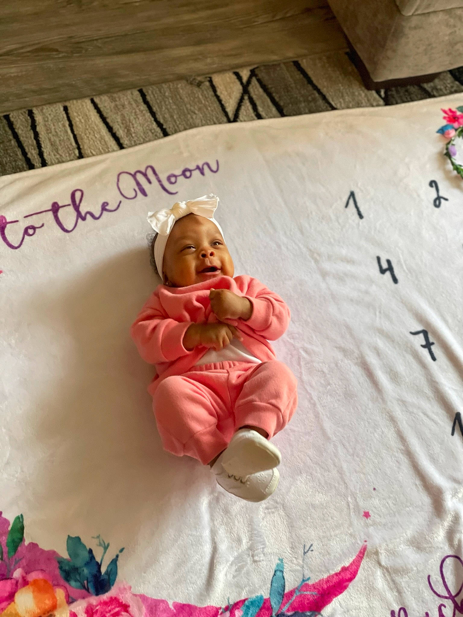 Alayah is registered to the contest to win money with this photo: baby, beauty, child, design, flooring, font, hardwood, linens, magenta, orange, peach, person, petal, photograph, pink, red, sugar_cake, sweetness, textile, toddler