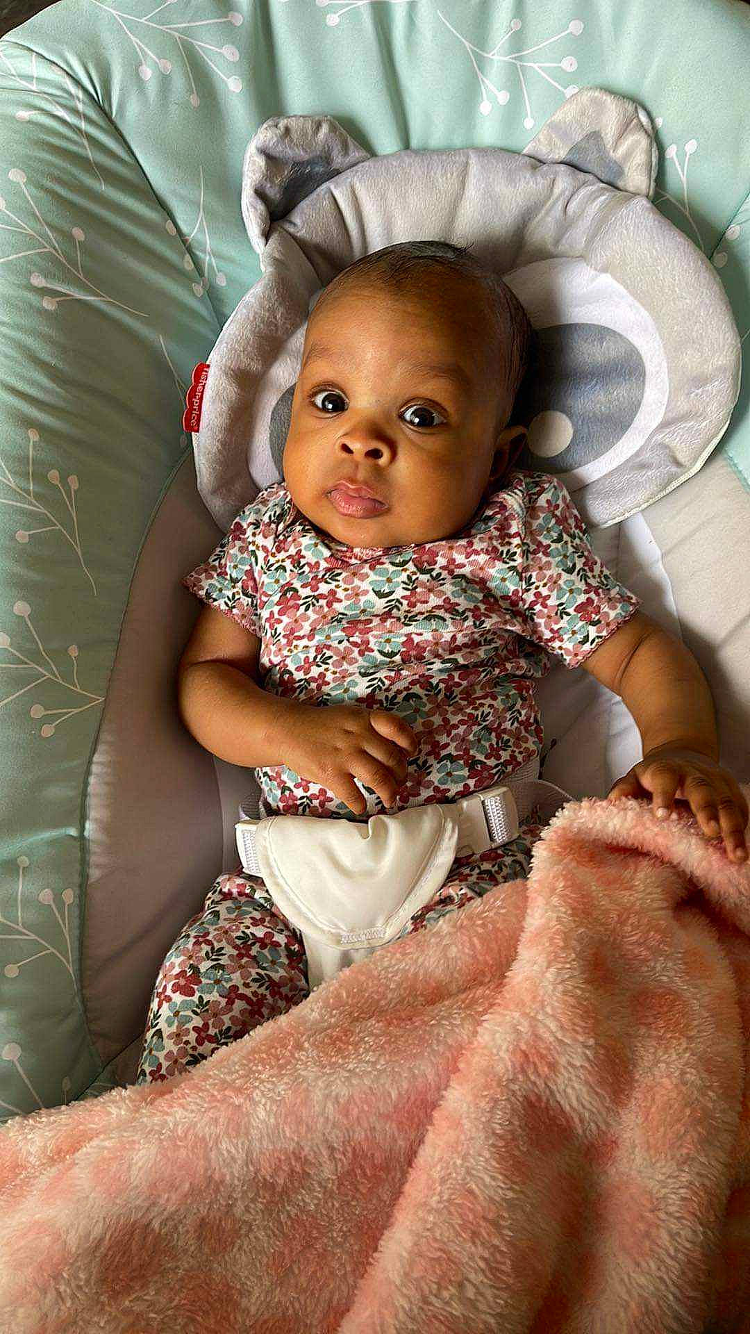 Alayah is registered to the contest to win money with this photo: baby, baby_toddler_clothing, brown, cheek, comfort, eye, face, flash_photography, hairstyle, happy, head, iris, mouth, organ, person, pink, sitting, skin, smile, textile