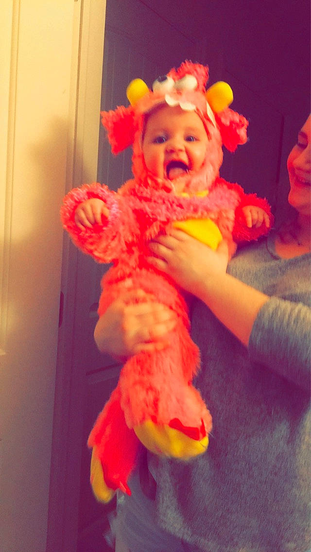 Luna is registered to the contest to win money with this photo: child, costume, fictional_character, fun, orange, peach, person, pink, play, stuffed_toy, tail, toddler, toy, yellow