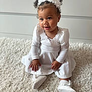 Tiyana a rejoint le concours — aidez-le/la à gagner de superbes lots ! baby, carpet, child, curly_hair, cute, fashion, happy, headband, indoor, innocence, person, pigtails, portrait, shoes, sitting, smile, soft_lighting, toddler, white_dress, young_child