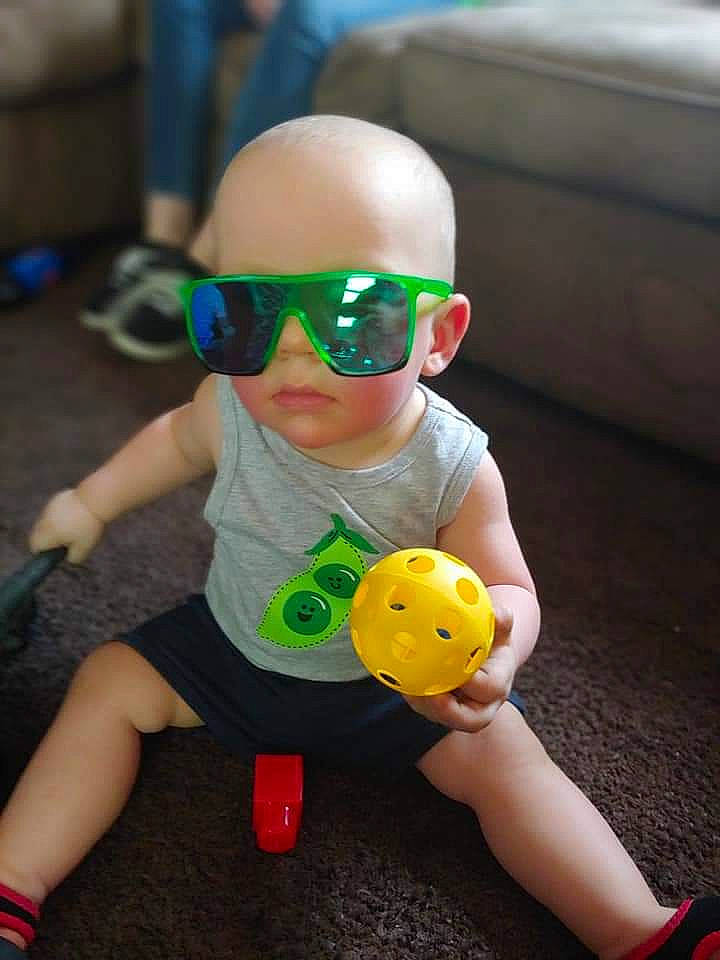 Hayden is registered to the contest to win money with this photo: ball, child, eyewear, glasses, person, personal_protective_equipment, play, sunglasses, toddler, toy