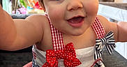 Madison joined the competition — help win amazing prizes! baby, child, smile, face, blue_eyes, dress, bow, red, white, blue, indoor, person, cute, happy, young, closeup, infant, sitting, apparel, portrait