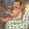 Madison joined the competition — help win amazing prizes! baby, child, smiling, happy, toy, stuffed_toy, tattoo, arm, chair, baby_chair, indoor, person, cute, playful, colorful, short_hair, clothing, skin, seated, joyful