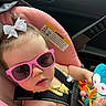 baby, child, car_seat, sunglasses, pink, white_bow, toy, blue_monkey, seatbelt, car_interior, cute, infant, child_safety, summer, accessory, baby_toy, portrait, closeup, person, seat