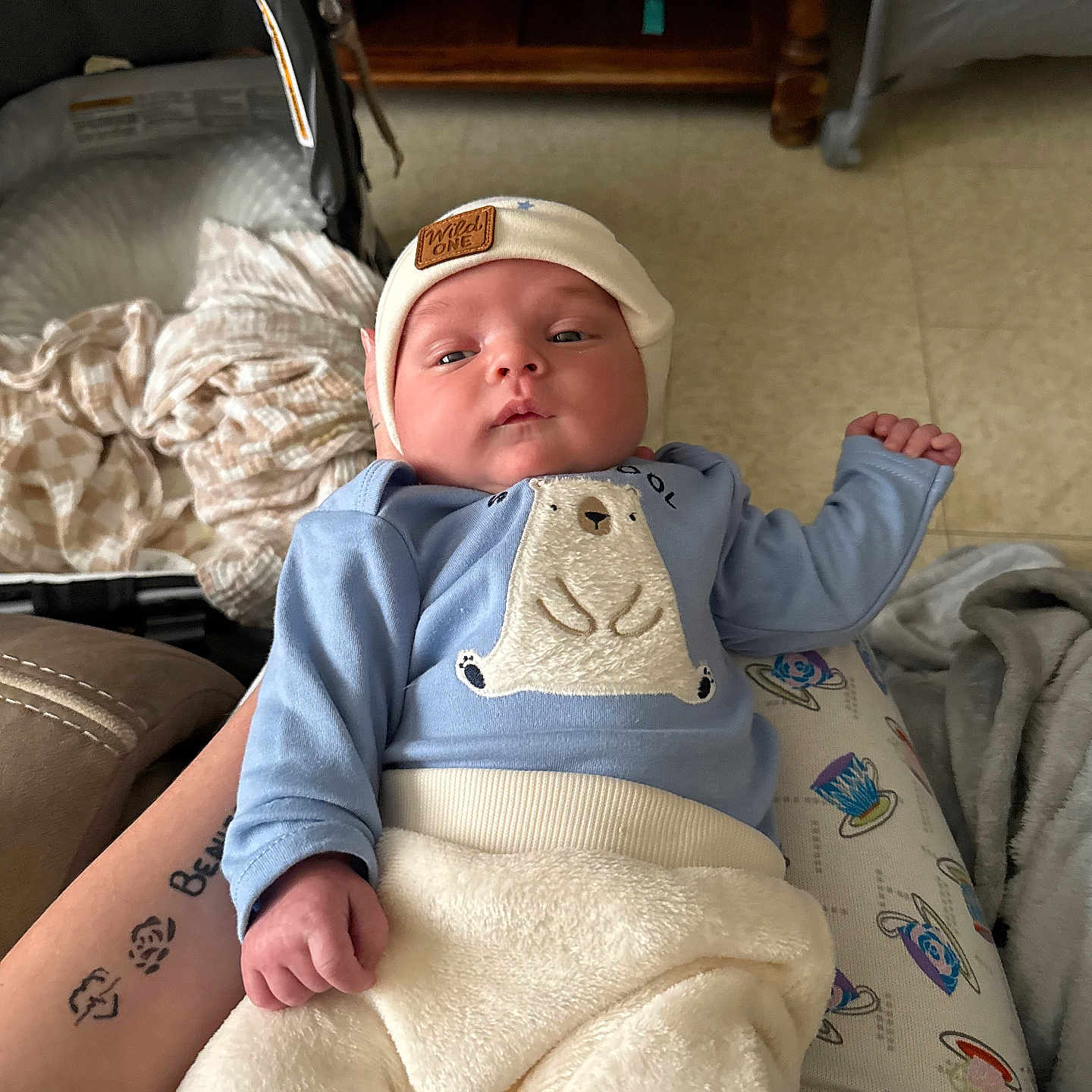 Ezekiel joined the competition — help win amazing prizes! baby, bed, blanket, bodypart, cap, clothing, couch, cushion, face, finger, furniture, hand, hat, head, newborn, person, photography, portrait, skin, tattoo