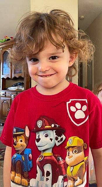 Lucas is registered to the contest to win money with this photo: baby_toddler_clothing, cheek, child, event, face, fictional_character, fun, happy, head, joy, organ, pattern, people, person, red, skin, sleeve, smile, standing, t_shirt