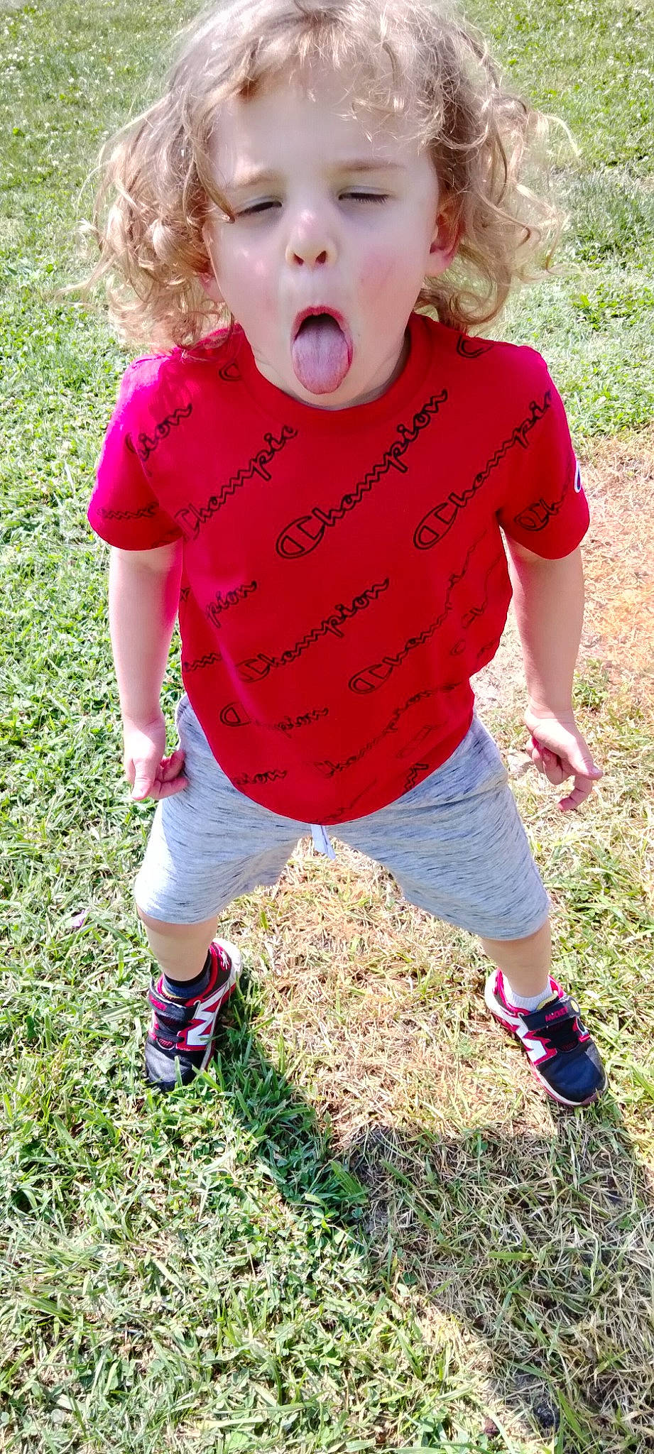 Lucas is registered to the contest to win money with this photo: baby_toddler_clothing, child, clothing, dress, footwear, fun, grass, happy, magenta, pattern, people_in_nature, person, pink, plant, shoe, shorts, sleeve, sneakers, summer, t_shirt