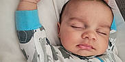 Brent joined the competition — help win amazing prizes! baby, sleeping, pajamas, arm, hand, face, closed_eyes, infant, cute, cozy, blanket, sleep, person, child, soft, rest, peaceful, indoors, young, lying_down
